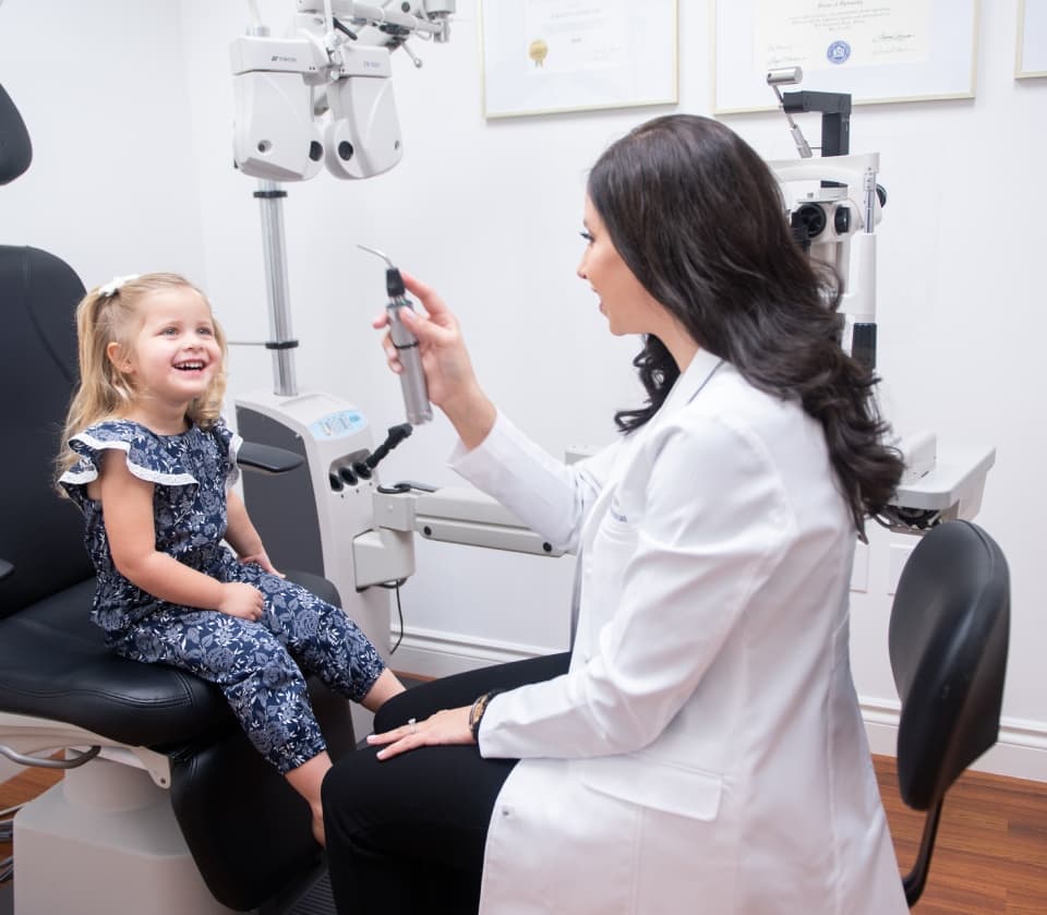 Dr. Zuriany Olive, an optometrist in Miami performing a kids eye exam.